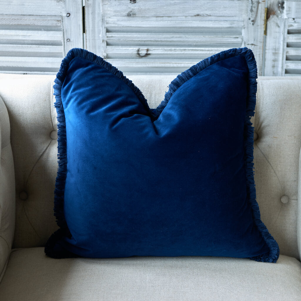 Navy velvet cushion with fluffy fringing