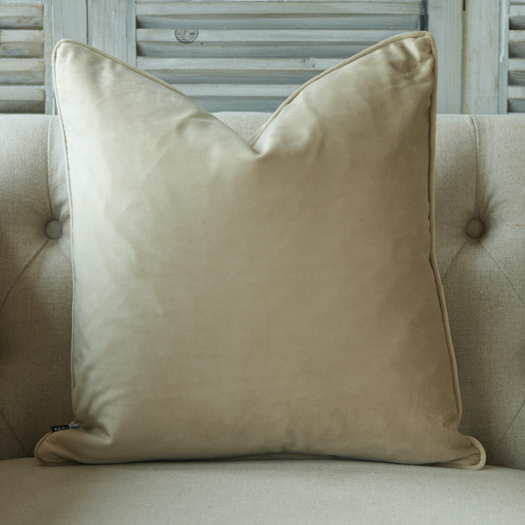 Luxe matte velvet cushion in champagne colour with piped edge