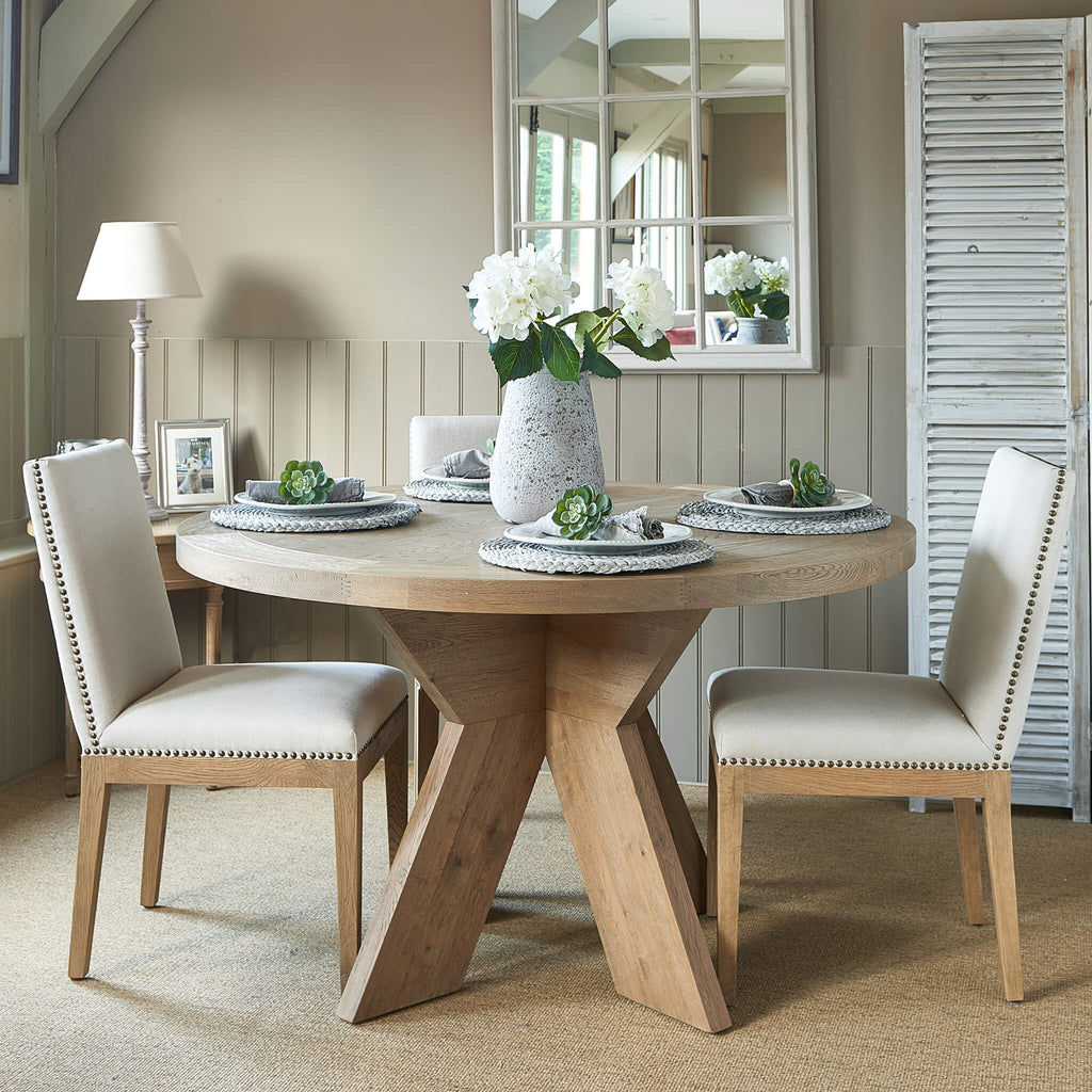 Newport round weathered oak dining table with contemporary crossed plank style base