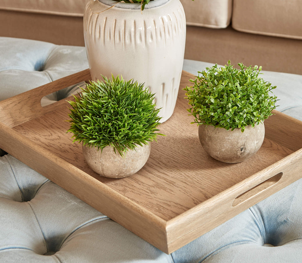 Duo of small stone pots, one with faux fern and the other with faux small-leaved plant